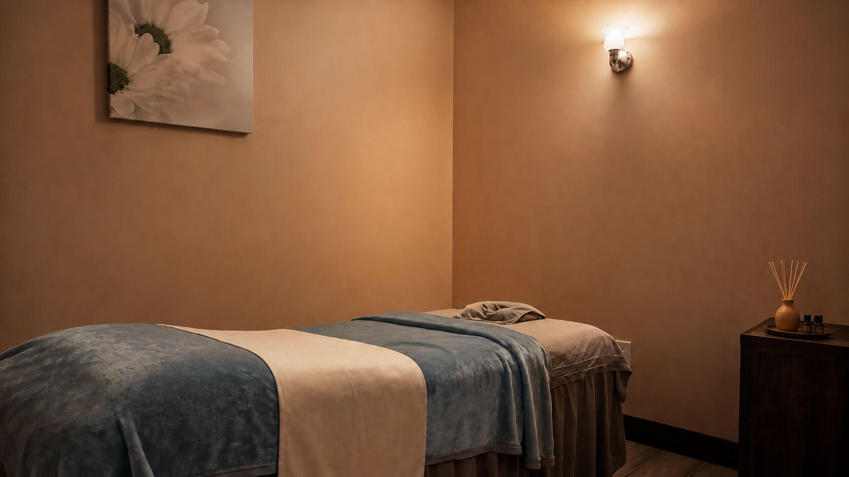Private massage room with warm lighting and massage bed
